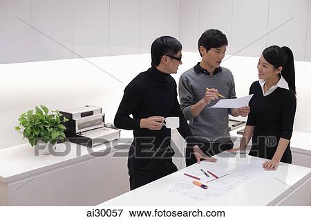 Three people working together in modern office View Large Photo Image Stock Photo - Three people working together in modern office. Fotosearch