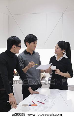 Three people working together in modern office View Large Photo Image Stock Photo - Three people working together in modern office. Fotosearch