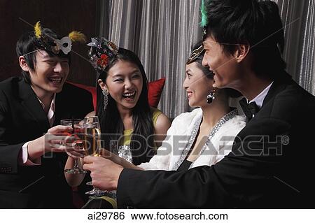 Two couples celebrating at a party, toasting each other View Large Photo Image Stock Photograph - Two couples celebrating at a party, toasting each other. Fotosearch
