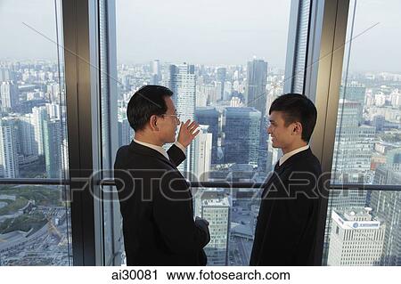 Two men talking in front of window with a view of the city of Beijing View Large Photo Image Stock Image - Two men talking in front of window with a view of the city of Beijing. Fotosearch