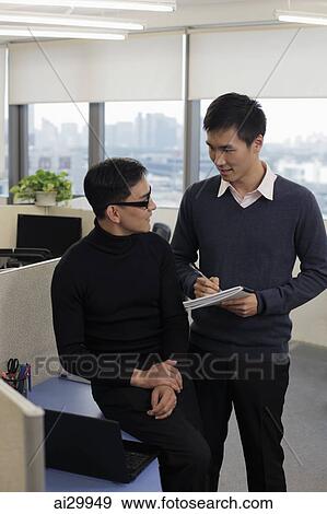 Two men working together in office View Large Photo Image Stock Photo - Two men working together in office. Fotosearch