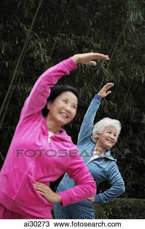Two older woman stretching together outdoors View Large Photo Image Stock Image - Two older woman stretching together outdoors. Fotosearch
