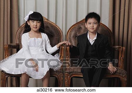Young boy and girl dressed in nice clothes holding hands View Large Photo Image Stock Photograph - Young boy and girl dressed in nice clothes holding hands. Fotosearch