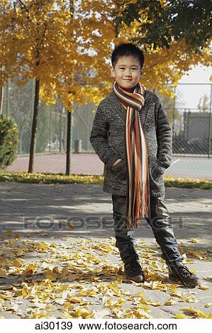 Young boy wearing sweater and scarf outdoors View Large Photo Image Stock Photo - Young boy wearing sweater and scarf outdoors. Fotosearch