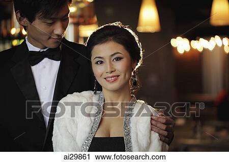 Young couple dressed elegantly at night View Large Photo Image Stock Image - Young couple dressed elegantly at night. Fotosearch