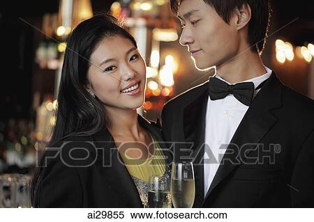 Young couple dressed up at night holding champagne glasses View Large Photo Image Stock Photography - Young couple dressed up at night holding champagne glasses. Fotosearch
