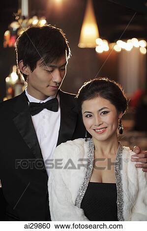 Young couple elegantly dressed at night View Large Photo Image Stock Image - Young couple elegantly dressed at night. Fotosearch