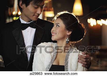 Young couple elegantly dressed looking at each other View Large Photo Image Stock Image - Young couple elegantly dressed looking at each other. Fotosearch