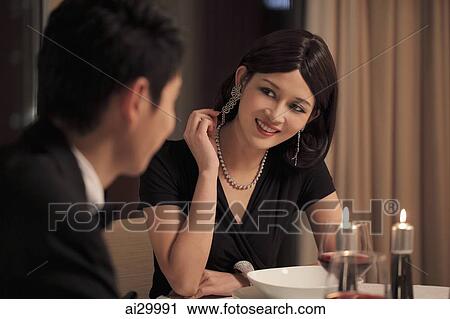 Young couple having a romantic dinner together View Large Photo Image Stock Image - Young couple having a romantic dinner together. Fotosearch