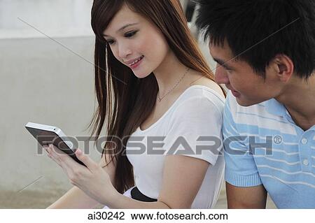 Stock Image - Young couple looking at digital tablet. Fotosearch