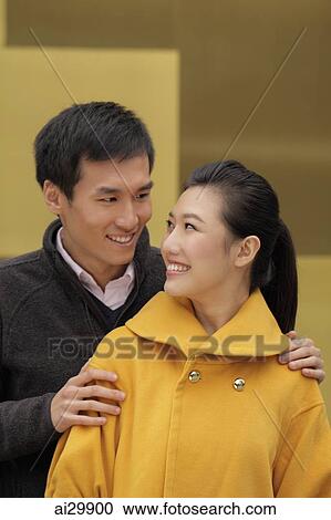 Young couple looking at each other and smiling. View Large Photo Image Stock Image - Young couple looking at each other and smiling.. Fotosearch