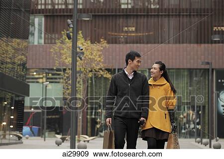 Young couple shopping together outdoors View Large Photo Image Stock Photo - Young couple shopping together outdoors. Fotosearch