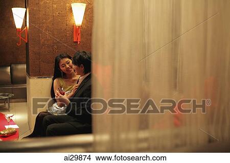 Young couple sitting in a club at night View Large Photo Image Picture - Young couple sitting in a club at night. Fotosearch