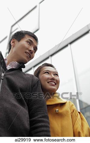 Young couple smiling together outdoors View Large Photo Image Stock Photo - Young couple smiling together outdoors. Fotosearch