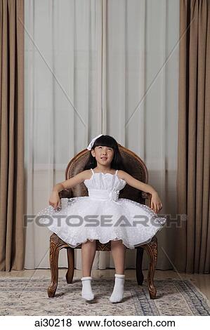 Young girl dressed up in white dress looking up View Large Photo Image Stock Photo - Young girl dressed up in white dress looking up. Fotosearch