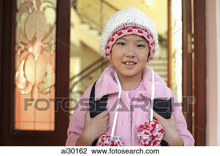 Young girl leaving her home in knitted cap and pink coat View Large Photo Image Stock Image - Young girl leaving her home in knitted cap and pink coat. Fotosearch