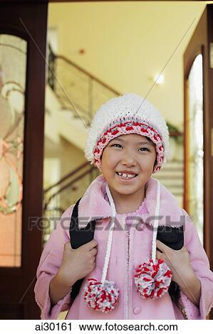 Young girl leaving her house in knitted hat and pink coat View Large Photo Image Stock Image - Young girl leaving her house in knitted hat and pink coat. Fotosearch