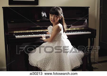 Young girl playing piano in white dress View Large Photo Image Stock Image - Young girl playing piano in white dress. Fotosearch