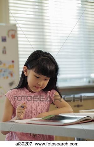Young girl studying in the kitchen View Large Photo Image Stock Photo - Young girl studying in the kitchen. Fotosearch
