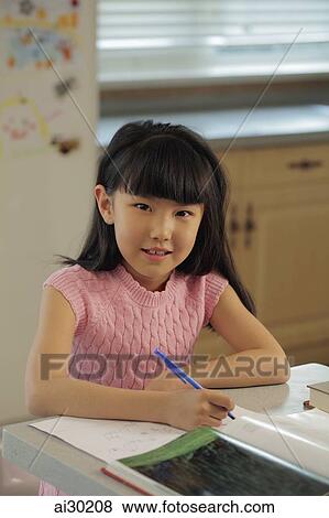 Young girl studying in the kitchen View Large Photo Image Stock Photo - Young girl studying in the kitchen. Fotosearch