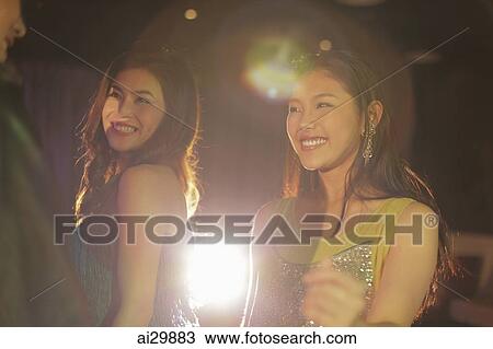 Stock Image - Young people dancing at night. Fotosearch