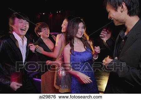 Young people dancing in a club at night View Large Photo Image Stock Photograph - Young people dancing in a club at night. Fotosearch