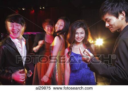 Stock Photography - Young people dancing in a club at night. Fotosearch