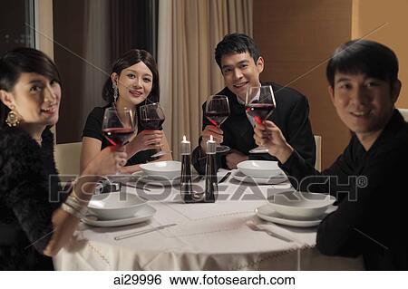 Young people drinking wine at a dinner party View Large Photo Image Stock Photograph - Young people drinking wine at a dinner party. Fotosearch