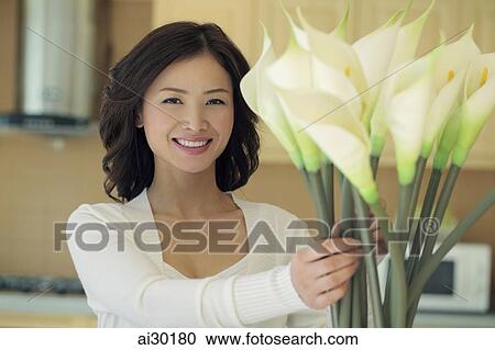 Young woman arranging flowers View Large Photo Image Stock Image - Young woman arranging flowers. Fotosearch