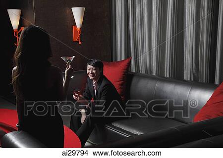 Young woman looking at young man in a club View Large Photo Image Picture - Young woman looking at young man in a club. Fotosearch