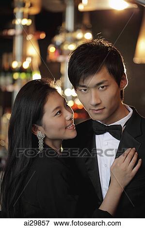 Young woman looking at young man in a tuxedo. View Large Photo Image Stock Photo - Young woman looking at young man in a tuxedo.. Fotosearch