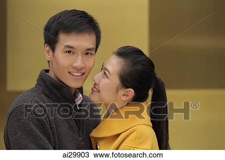 Young woman looking at young man while he looks at camera View Large Photo Image Stock Image - Young woman looking at young man while he looks at camera. Fotosearch