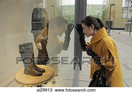 Young woman looking in shop window shopping View Large Photo Image Stock Image - Young woman looking in shop window shopping. Fotosearch