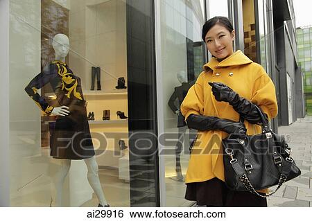 Young woman shopping outdoors View Large Photo Image Stock Photograph - Young woman shopping outdoors. Fotosearch