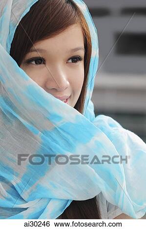 Young woman wearing a blue scarf around her head View Large Photo Image Stock Photograph - Young woman wearing a blue scarf around her head. Fotosearch