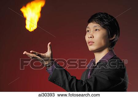 A magician levitates a ball of fire View Large Photo Image Stock Image - A magician levitates a ball of fire. Fotosearch