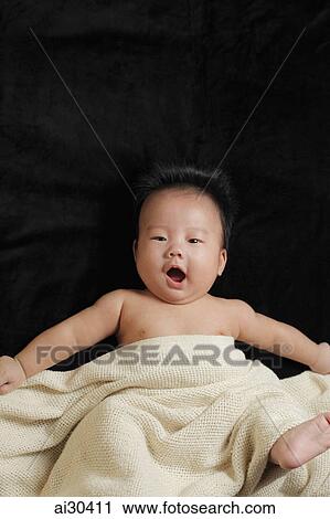 Baby boy wrapped in a blanket laughing View Large Photo Image Stock Image - Baby boy wrapped in a blanket laughing. Fotosearch