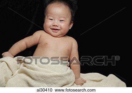 Baby boy wrapped in a blanket smiling View Large Photo Image Stock Image - Baby boy wrapped in a blanket smiling. Fotosearch