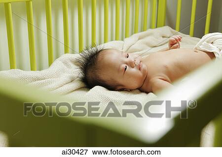 Baby sleeping in his crib View Large Photo Image Stock Photo - Baby sleeping in his crib. Fotosearch
