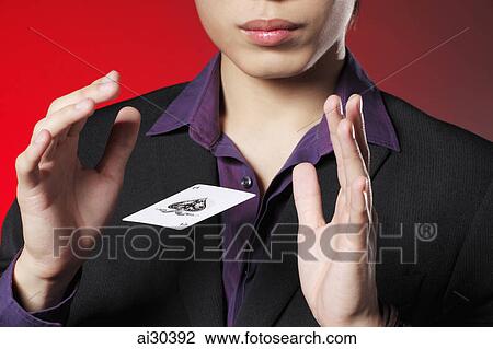 Cropped shot of a magician with a playing card floating between his hands. View Large Photo Image Stock Image - Cropped shot of a magician with a playing card floating between his hands.. Fotosearch