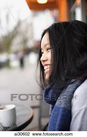 Head shot of young woman laughing at a cafe View Large Photo Image Stock Image - Head shot of young woman laughing at a cafe. Fotosearch