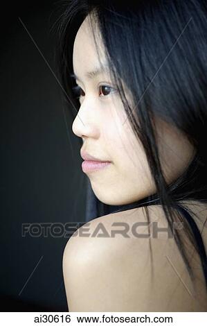 Stock Photograph - Head shot of young woman's profile. Fotosearch