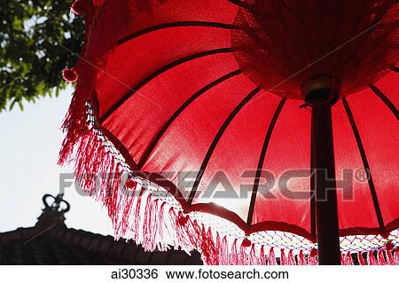 Low angle of red Balinese umbrella. Indonesia, Bali View Large Photo Image Stock Photograph - Low angle of red Balinese umbrella. Indonesia, Bali. Fotosearch