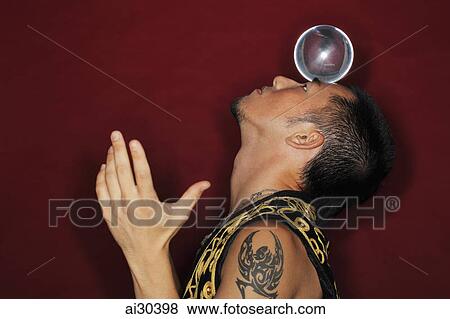 Man balancing crystal ball on his head View Large Photo Image Stock Photo - Man balancing crystal ball on his head. Fotosearch