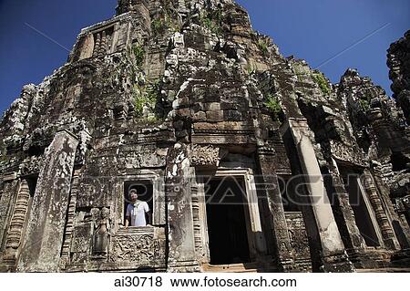 Man looking out a stone window at Angkor Wat, Cambodia View Large Photo Image Stock Photo - Man looking out a stone window at Angkor Wat, Cambodia. Fotosearch