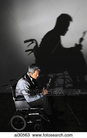 Man sitting in a wheelchair holding trophy, his shadow on the wall View Large Photo Image Stock Image - Man sitting in a wheelchair holding trophy, his shadow on the wall. Fotosearch