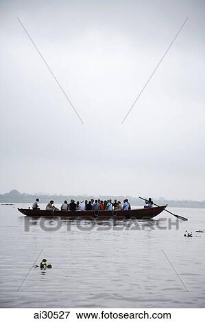 Stock Photo - People in a boat on the Ganges River, India. Fotosearch
