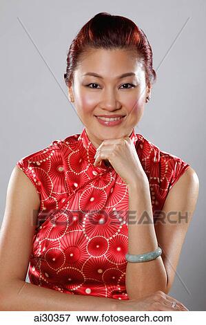 Portrait of woman wearing Cheongsam and jade bracelet View Large Photo Image Stock Photo - Portrait of woman wearing Cheongsam and jade bracelet. Fotosearch