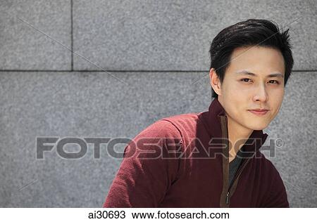 Stock Image - Portrait of young man outside. Fotosearch