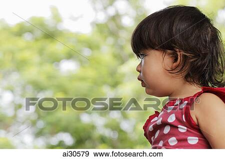 Stock Photo - Profile of young girl outside. Fotosearch